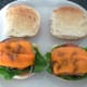 Cheesy bacon is laid on salad beds on the rolls