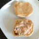Lettuce and onion in chilli sauce is spread on roll base