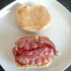 Bacon tops the tomato slices