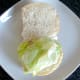 Lettuce bed is arranged on bread roll