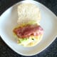 Bacon strips are laid on mashed egg