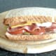 Garlic mayo BLT with crispy bacon corn snacks is closed over