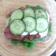 Pickled cucumber slices are laid on top of mozzarella