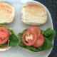 Sliced tomato on lettuce and onion