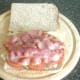 Bacon is laid on top of lettuce and tomato