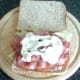 Garlic mayo is spread over bacon
