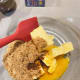 In a large bowl, combine the brown sugar, butter, egg yolk, and vanilla essence. Use a spatula to mix the ingredients.