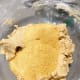 Add the ground cornflakes to the mixture. Mix to combine.