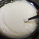 Add 2-3 ice cubes and churn well while adding cold water.
