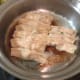 Here the water has cooked off and the potstickers are now frying. You can see the crispy brown lattice forming on the bottom of the pan.