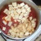 Diced potatoes and parsnips are added to curry sauce