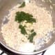 Spinach and garlic are added to cooked rice