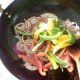 Stir frying red onion and bell peppers
