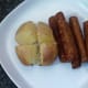 Plated baked potato and vegan sausages