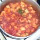 Chopped fresh mint leaves are added to simmering curry