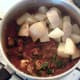 Boiled and cooled potato chunks are added to curry