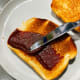 Spread the coconut jam on the crispy toast.