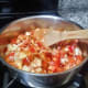 Add the diced onion, red pepper, tomato, paprika and salt to the pan and stir well.