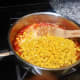 Add the corn and the milk with the diluted cornstarch and continue to stir well.