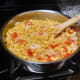 Bring the sauce to a gentle simmer and continue stirring until the onions are golden in color.
