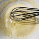 Add oil to the mixture and stir to combine.