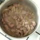 Chicken stock is added to browned lamb