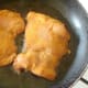 Chicken thighs are put on to fry