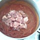 Chopped chicken thighs are added to curry sauce