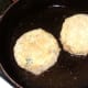 breaded chickpea potato cakes are added to frying pan