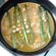 Beaten eggs are poured over asparagus and chickpeas