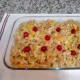 Pour the mixture into your greased casserole. If you wish, add a few cherries on top!