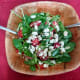 Pour the salad dressing over the salad, then sprinkle the crumbled cheese on top. Gently combine all the ingredients together.