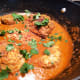 Chicken simmering in tikka masala sauce