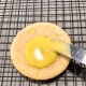 Use a palate knife or a pipping bag to decorate the cookies.