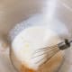 In a mixing bowl, combine the warm milk, yeast, and sugar. Stir to combine.