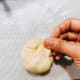 Fold the edges over the center and pull it over to cover the filling. Shape the dough into a smooth ball, tucking the ends underneath to close.
