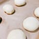 Arrange the dough balls on a baking pan that is lined with parchment paper.