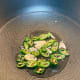Heat the oil to medium-high heat in a wok, and saute the garlic with serrano pepper until light brown.