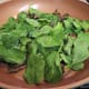 Adding the baby spinach to the pan
