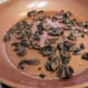 Sauté pan with cooked mushroom-onion mixture heated in the olive oil.