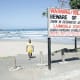 A shark warning sign on the beach at Second Beach.