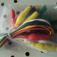 Plastic coloured copper wire with attached alligator clips to allow for various circuit configurations.