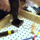 After components were laid out for adequate spacing, the battery comparment, the knife switch and the screw-base lamp holders were screwed onto the peg board using a drill to pre-make holes and then a screw driver to screw in the screws.