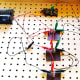 Attach a sixth connecting wire from the right side of the first bulb from the switch to the arm of the switch.