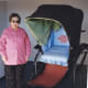 My mother-in-law standing next to a sedan chair