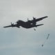 Paratroopers jumping out of a C-130 during a mass parachute jump at Andrews, AFB, MD.