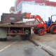 Ripping out planters and other fixtures inside the Poteau Pocket Park (Town Square)