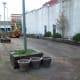 Ripping out planters and other fixtures inside the Poteau Pocket Park (Town Square)