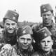 Bosnian members of the 13th SS Division. Note the traditional Fezzes (with German Eagle and Skull). Note also the middle-eastern scimitar swords on their collar patches.