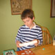 3. Guess how many books the eggs will hole. Set a strong book on top of the eggshells as a base..